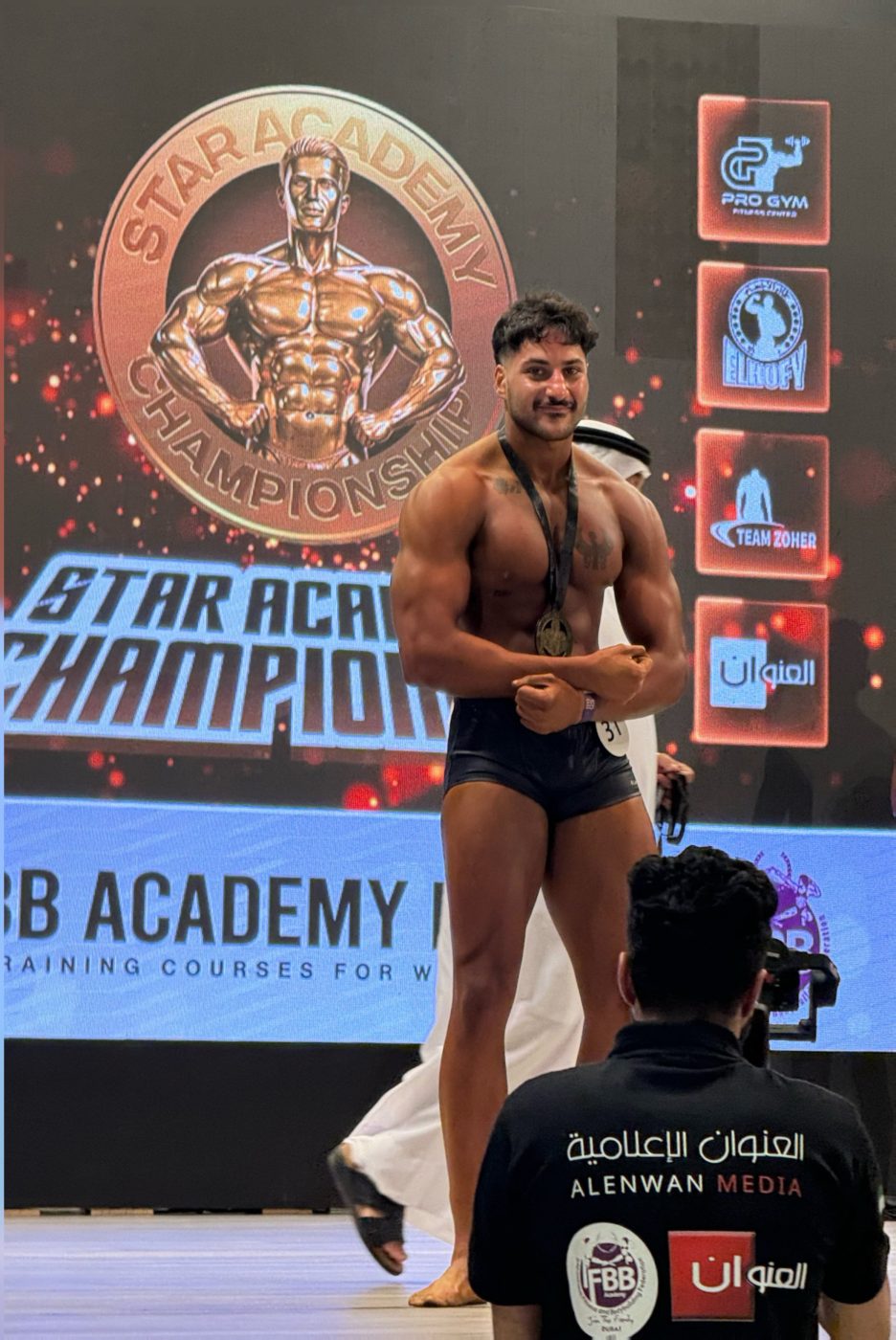 Coach Bonga winning a bodybuilding medal in Dubai